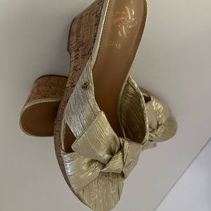 Brand  new with box .  Slip on and off wedge. Beautiful gold color.